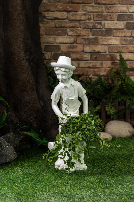 The boy wearing a hat is watering the flowers
